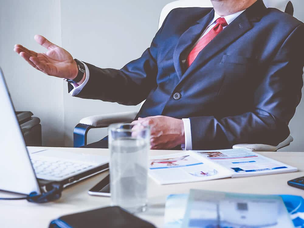 Man in suit sitting at desk