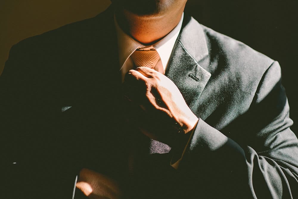 Person straightening his tie