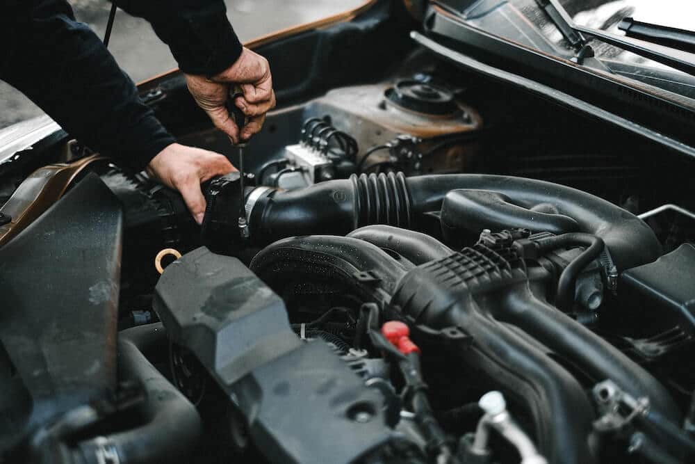 person working on car engine